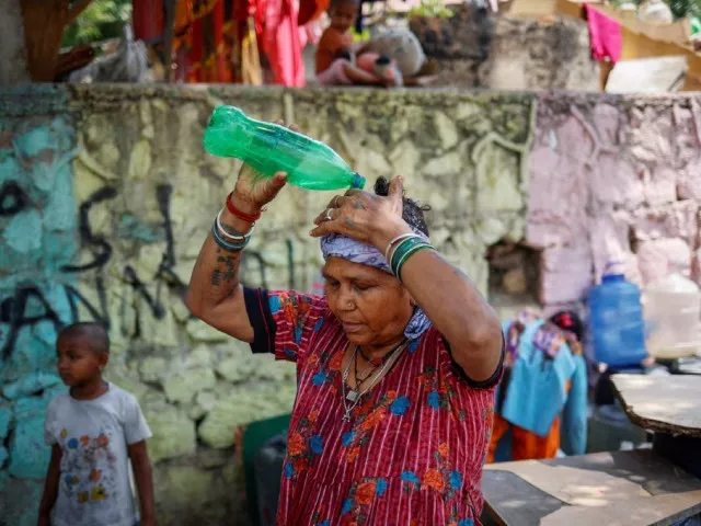 a woman pours water on her head after filling her containers with drinking water from a municipal tanker on a hot summer day in new delhi india may 21 2024 photo reuters a woman pours water on her head after filling her containers with drinking water from a municipal tanker on a hot summer day in new delhi india may 21 2024 photo reuters