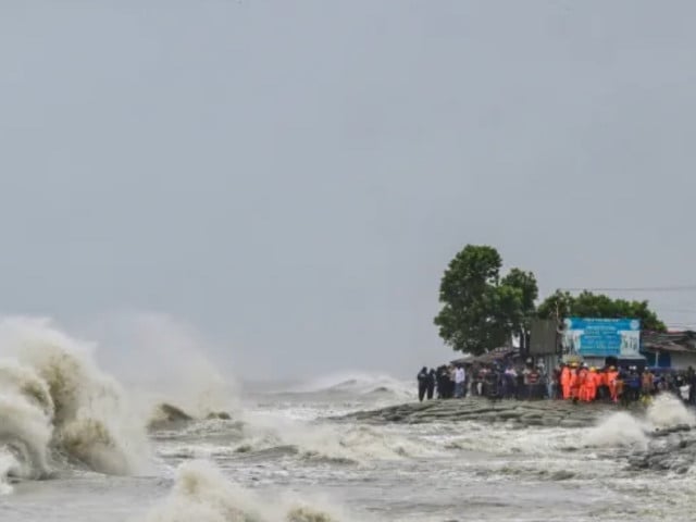 people gather along the seashore amid rainfall in kuakata ahead of cyclone remal s landfall in bangladesh photo munir uz zaman afp