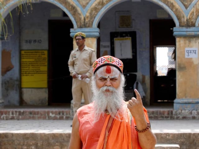 a sadhu or a hindu holy man shows his ink marked finger after voting outside a polling station during the fifth phase of india s general election in ayodhya uttar pradesh india may 20 2024 photo reuters