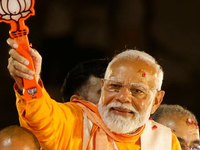 india s prime minister narendra modi shows the bharatiya janata party bjp symbol during a roadshow as part of an election campaign in varanasi india may 13 2024 photo reuters