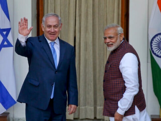 file india s prime minister narendra modi right gestures and israeli prime minister benjamin netanyahu waves to the media as they arrive for a meeting in new delhi india jan 15 2018 photo a