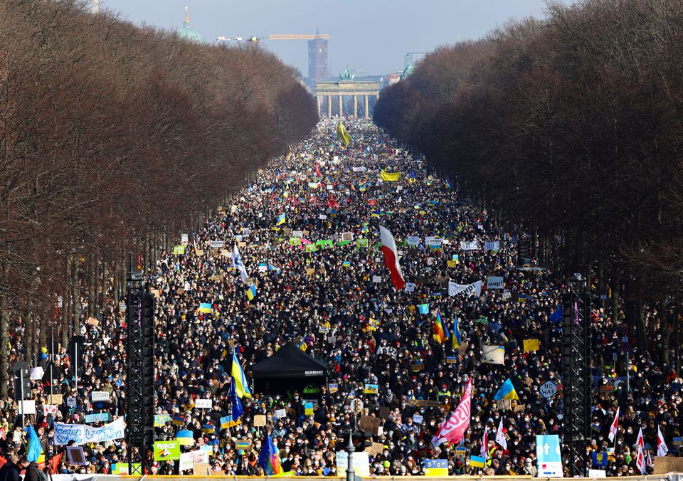 demonstrators hold placards amongst others holding ukrainian flags during an anti war protest after russia launched a massive military operation against ukraine at the brandenburg gate in berlin germany february 27 2022 photo reuters