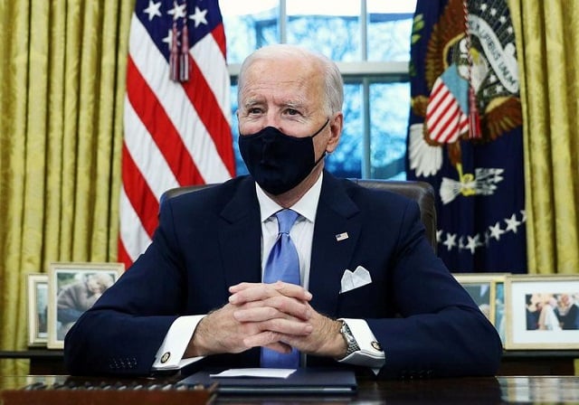 us president joe biden signs executive orders in the oval office of the white house in washington after his inauguration as the 46th president of the united states us january 20 2021 photo reuters