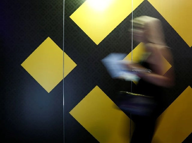 a woman walks past an exhibition stand showing the logo of binance at the delta summit in st julian s malta october 4 2018 photo reuters a woman walks past an exhibition stand showing the logo of binance at the delta summit in st julian s malta october 4 2018 photo reuters