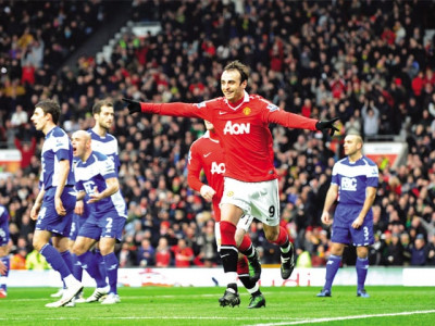 berbatov hat trick keeps unbeaten united at the top