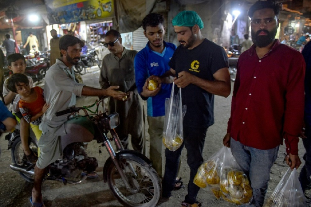 Cooked in bulk, biryani is also a staple of charity donations. PHOTO: AFP