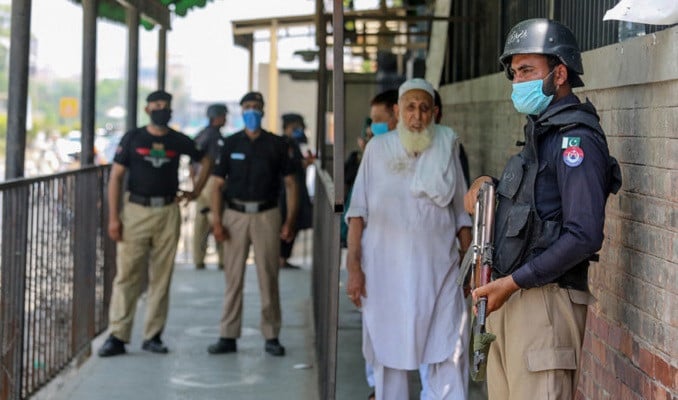 security personnel l and r stand guard outside the district court building following the killing of a man allegedly accused of blasphemy in peshawar on july 29 2020 afp file