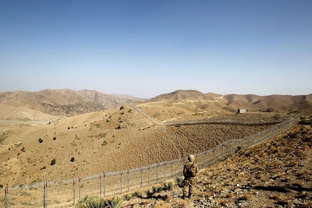 a pakistan army soldier stands guard along the border fence outside the kitton outpost on the border with afghanistan in north waziristan october 18 2017 photo reuters file