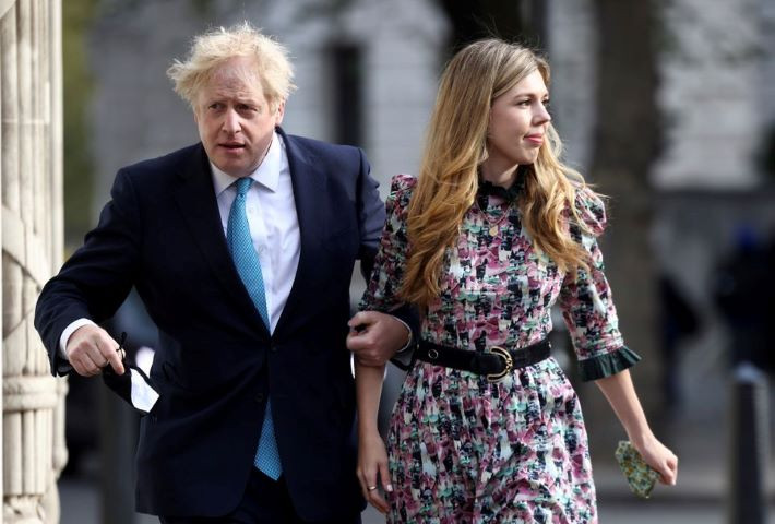 britain s prime minister boris johnson and partner carrie symonds walk to westminster polling station to vote in london britain may 6 2021 reuters henry nicholls file photo