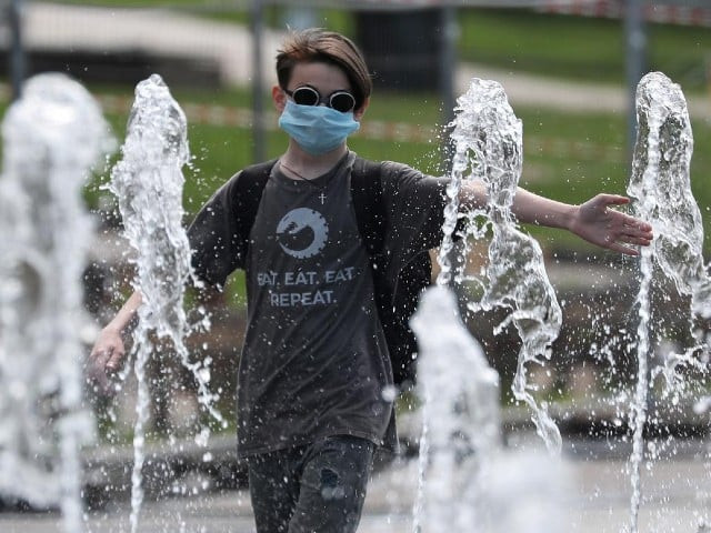 a boy wearing a protective face mask plays in a fountain after local authorities eased lockdown restrictions imposed to prevent the spread of the coronavirus disease covid 19 in moscow russia june 12 2020 photo reuters file a boy wearing a protective face mask plays in a fountain after local authorities eased lockdown restrictions imposed to prevent the spread of the coronavirus disease covid 19 in moscow russia june 12 2020 photo reuters file