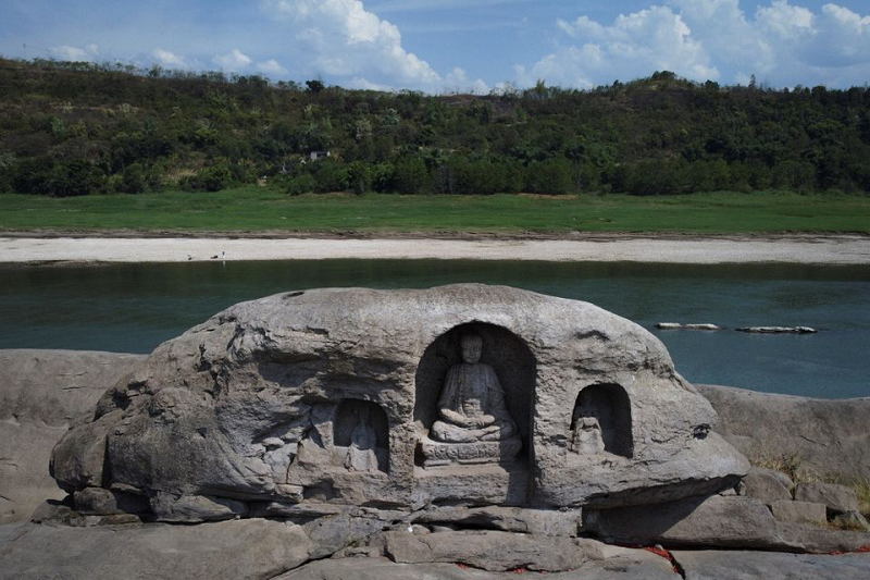 a once submerged buddhist statue sits on top of foyeliang island reef in the yangtze river which appeared after water levels fell due to a regional drought in chongqing china august 20 2022 photo reuters