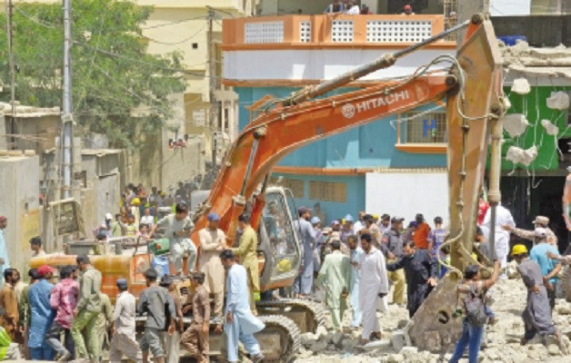 karachi metropolitan corporation workers use heavy machinery to tear down structures deemed illegal during an on going anti encroachment operation in orangi town photo online