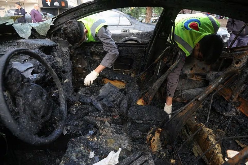 civil defence members check a burnt car in the aftermath of what security sources said was an israeli drone strike in beirut s southern suburbs of dahiyeh lebanon january 3 2024 photo reuters