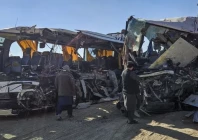 afghan residents inspect the accident site as they stand near the remains of a bus following its collision with a coal truck on a highway between kabul and southern kandahar city in the andar district of ghazni province on december 19 afp