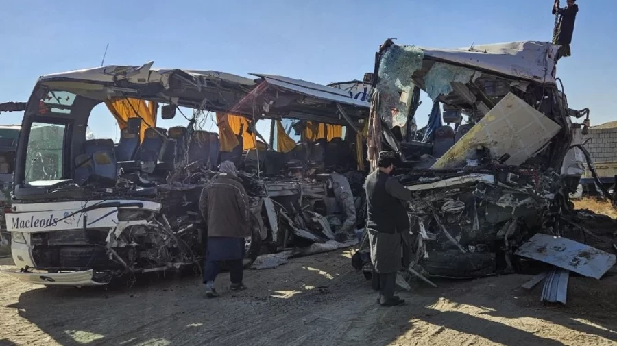 afghan residents inspect the accident site as they stand near the remains of a bus following its collision with a coal truck on a highway between kabul and southern kandahar city in the andar district of ghazni province on december 19 afp