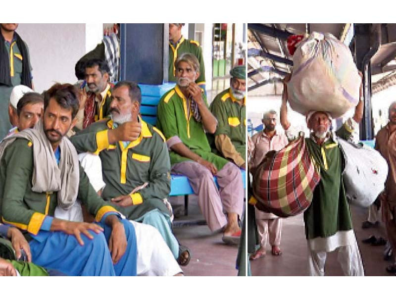 from left to right tense porters await passengers while one of their senior colleagues skilfully balances his customer s stuff wrapped in large pieces of cloth photo express