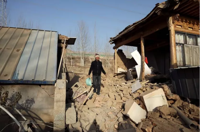a man walks on the rubble next to a damaged house following the earthquake that rocked gansu s jishishan county in haidong qinghai province china december 20 2023 photo reuters a man walks on the rubble next to a damaged house following the earthquake that rocked gansu s jishishan county in haidong qinghai province china december 20 2023 photo reuters