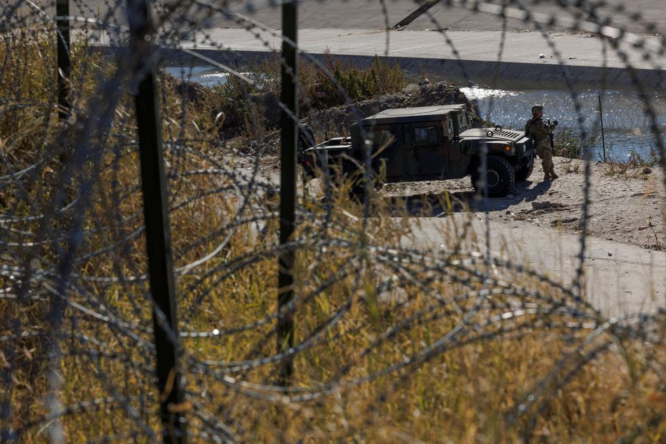 a member of the texas national guard stands by a vehicle along the rio bravo river the border between mexico and the u s as seen from el paso texas u s december 22 2022 photo reuters carlos barria