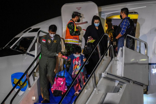 an indonesian airforce personnel helps a girl down the stairs of the aircraft as indonesian citizens who were evacuated from kabul afghanistan arrive at halim perdanakusuma airbase in jakarta indonesia august 21 2021 in this photo taken by antara foto photo reuters an indonesian airforce personnel helps a girl down the stairs of the aircraft as indonesian citizens who were evacuated from kabul afghanistan arrive at halim perdanakusuma airbase in jakarta indonesia august 21 2021 in this photo taken by antara foto photo reuters