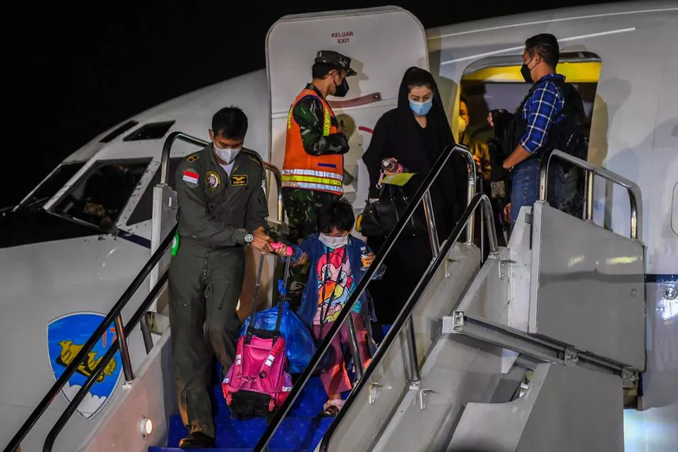 an indonesian airforce personnel helps a girl down the stairs of the aircraft as indonesian citizens who were evacuated from kabul afghanistan arrive at halim perdanakusuma airbase in jakarta indonesia august 21 2021 in this photo taken by antara foto photo reuters an indonesian airforce personnel helps a girl down the stairs of the aircraft as indonesian citizens who were evacuated from kabul afghanistan arrive at halim perdanakusuma airbase in jakarta indonesia august 21 2021 in this photo taken by antara foto photo reuters