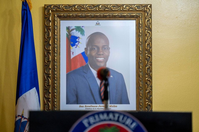 a picture of the late haitian president jovenel moise hangs on a wall before a news conference by interim prime minister claude joseph at his house almost a week after his assassination in port au prince haiti july 13 2021 photo reuters
