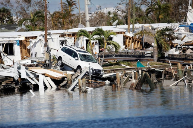 a destroyed car is seen in the matanzas pass after hurricane ian caused widespread destruction in fort myers beach florida u s october 1 2022 reuters marco bello a destroyed car is seen in the matanzas pass after hurricane ian caused widespread destruction in fort myers beach florida u s october 1 2022 reuters marco bello