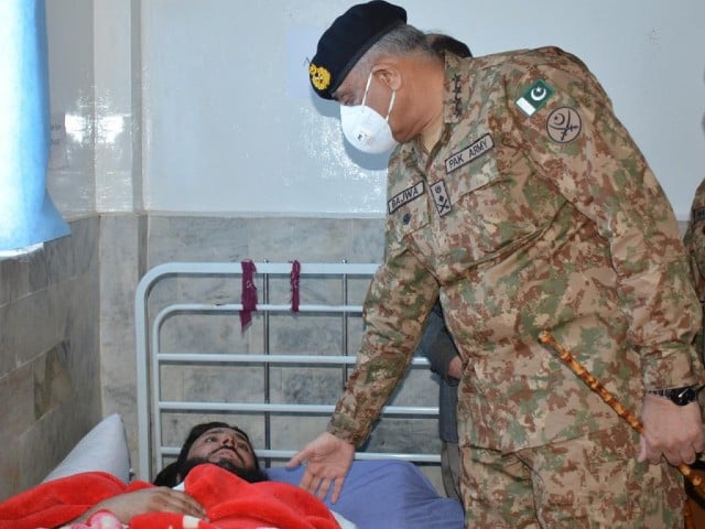 chief of army staff general qamar javed bajwa inquiring the health of an injured of peshawar blast photo express