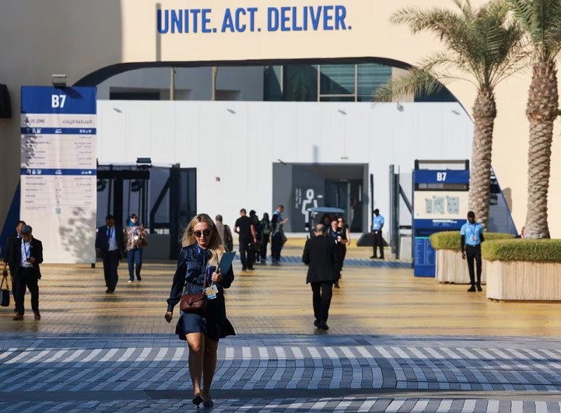 People walk at Dubai's Expo City during COP28 in Dubai, UAE, December 11, 2023. PHOTO: REUTERS