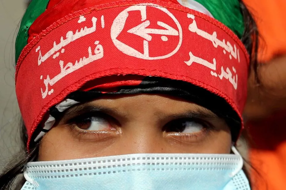a girl wearing a protective face mask and the headband of the popular front for the liberation of palestine pflp looks on during a rally to show solidarity with hunger striking palestinian prisoner maher al akhras who is held by israel in gaza city october 12 2020 photo reuters file a girl wearing a protective face mask and the headband of the popular front for the liberation of palestine pflp looks on during a rally to show solidarity with hunger striking palestinian prisoner maher al akhras who is held by israel in gaza city october 12 2020 photo reuters file