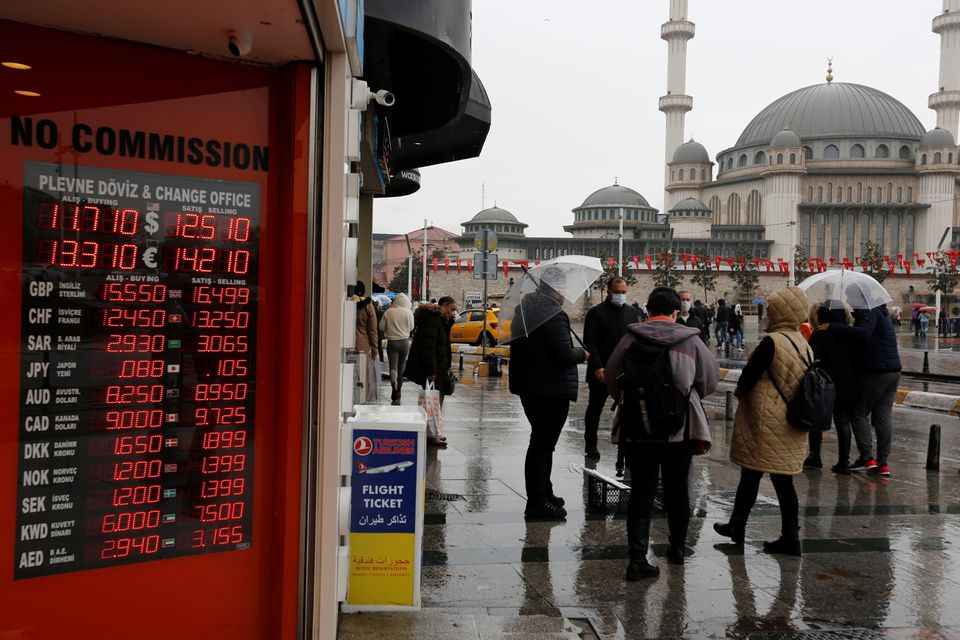 people stand outside a currency exchange office in istanbul turkey november 23 2021 photo reuters