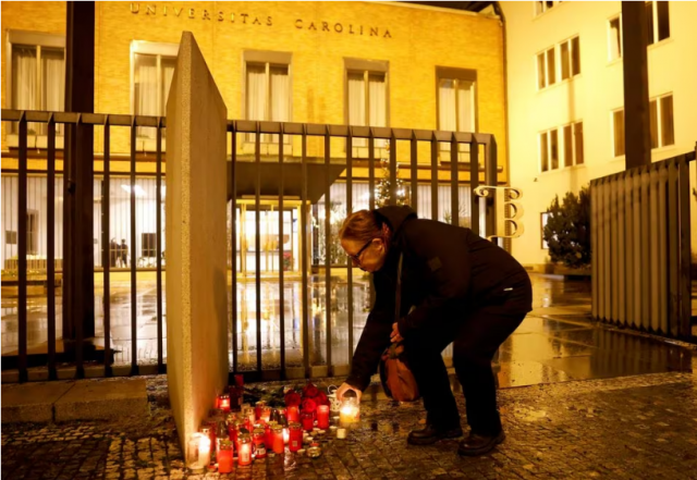 a woman lights a candle in front of charles university main building following the shooting at one of it s buildings in prague czech republic december 21 2023 photo reuters a woman lights a candle in front of charles university main building following the shooting at one of it s buildings in prague czech republic december 21 2023 photo reuters