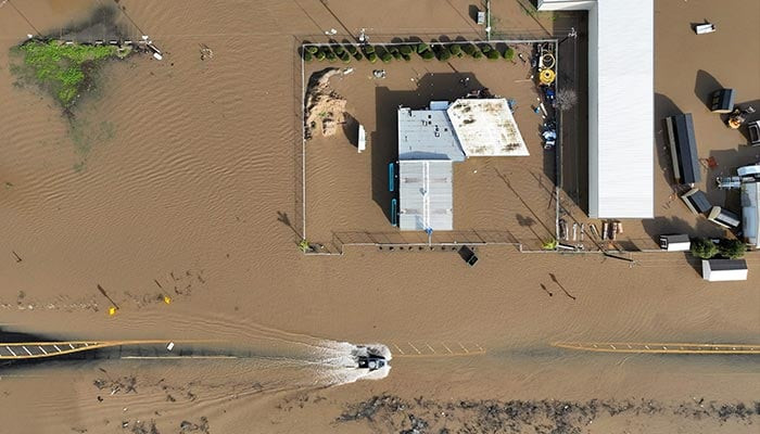 this aerial view shows vehicles driving on a flooded road in merced california on january 10 2023 photo afp