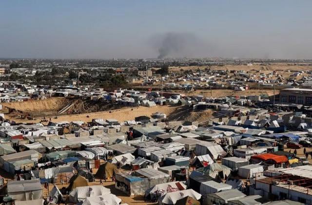 tent camp housing displaced palestinians as smoke rises in the distance due to an israeli ground operation in khan younis as seen rafah in the southern gaza strip january 22 2024 photo reuters