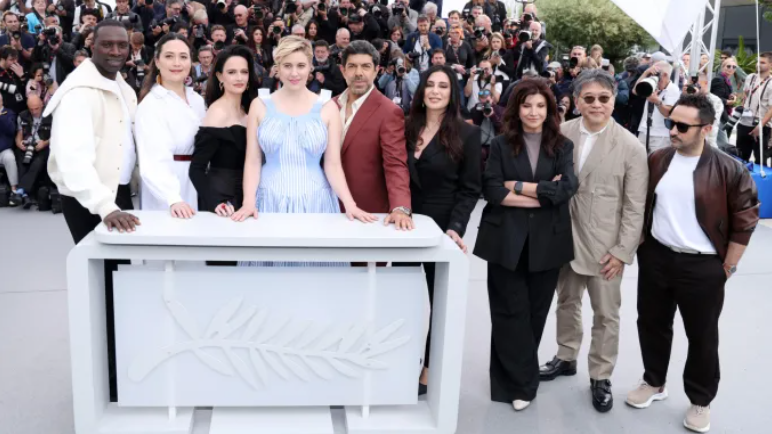 the cannes film festival 2024 jury led by greta gerwig from left to right omar sy lily gladstone eva green president of the jury greta gerwig pierfrancesco favino nadine labaki ebru ceylan hirokazu kore eda and juan antonio bayona courtesy of pascal le segretain