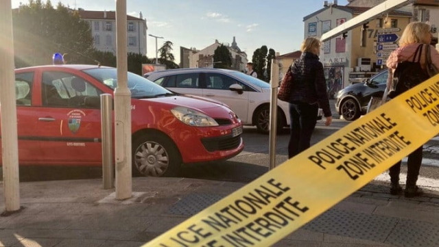 police tape is seen at the scene where an officer was stabbed in front of a police station in cannes france on november 8 2021 photo reuters