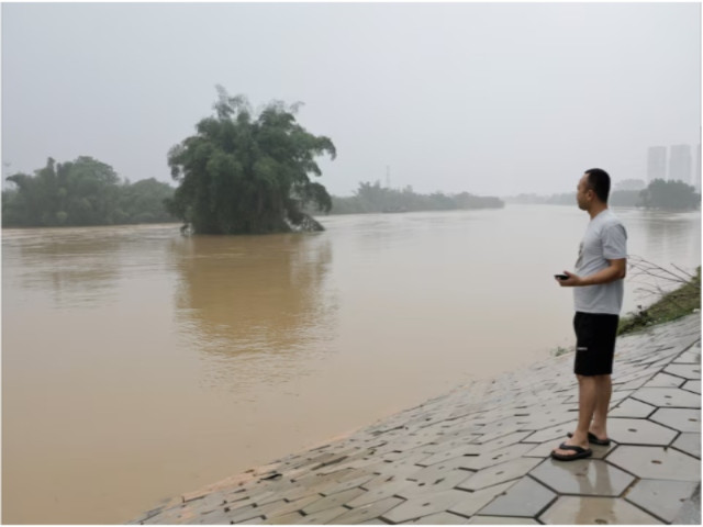 resident looks on as he stands near a flooded river following heavy rainfall in qingyuan guangdong province china april 22 2024 reuters tingshu wang