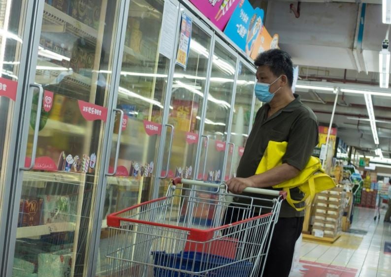 a man looks at frozen food products in a supermarket following an outbreak of the coronavirus disease covid 19 in beijing china august 13 2020 photo reuters