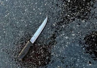 a knife found at the scene lies on pavement after a man who was later shot dead by police killed four members of his extended family including two children and stabbed two police officers at a home in the queens borough of new york city u s december 3 2023 photo reuters