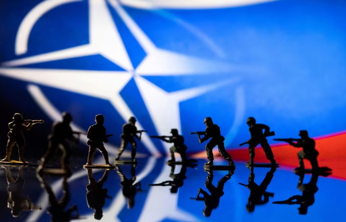 army soldier figurines are displayed in front of the nato logo and russian flag colours background in this illustration taken february 13 2022 photo reuters