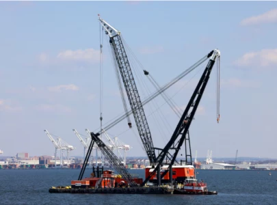 massive crane put in place to clear baltimore bridge debris as crews assess damage
