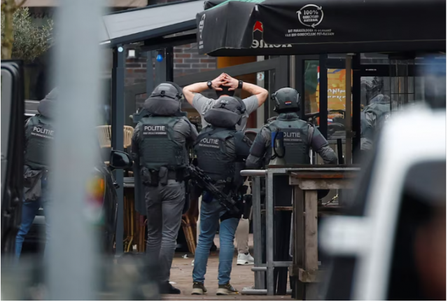 police officers detain a person near the cafe petticoat where several people were being held hostage in ede netherlands march 30 2024 reuters piroschka van de wouw police officers detain a person near the cafe petticoat where several people were being held hostage in ede netherlands march 30 2024 reuters piroschka van de wouw