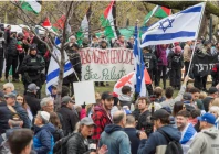 police stand between counter protesters and a protest encampment in support of palestinians during the ongoing conflict between israel and the palestinian islamist group hamas at mcgill university s campus in montreal quebec canada may 2 2024 reuters peter mccabe