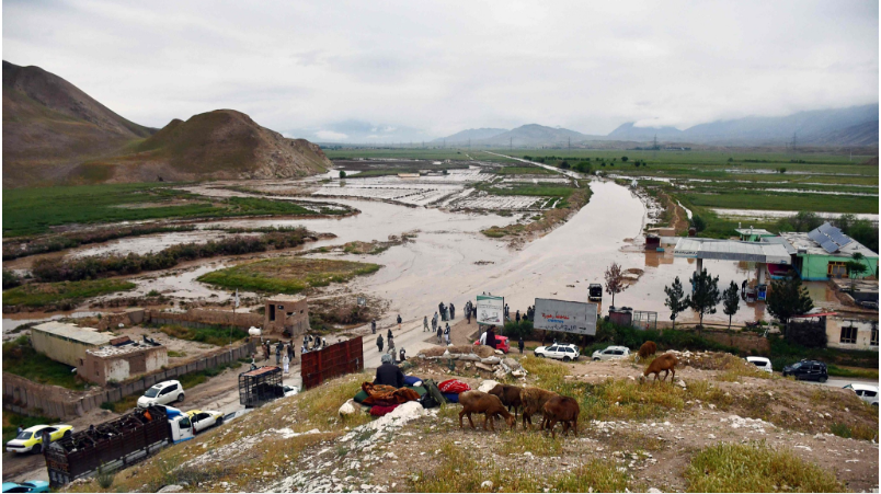 afgan people gather along a road before a flooded area between samangan and mazar i sharif following a flash flood after a heavy rainfall in feroz nakhchir district of samangan province on may 11 2024 cfp