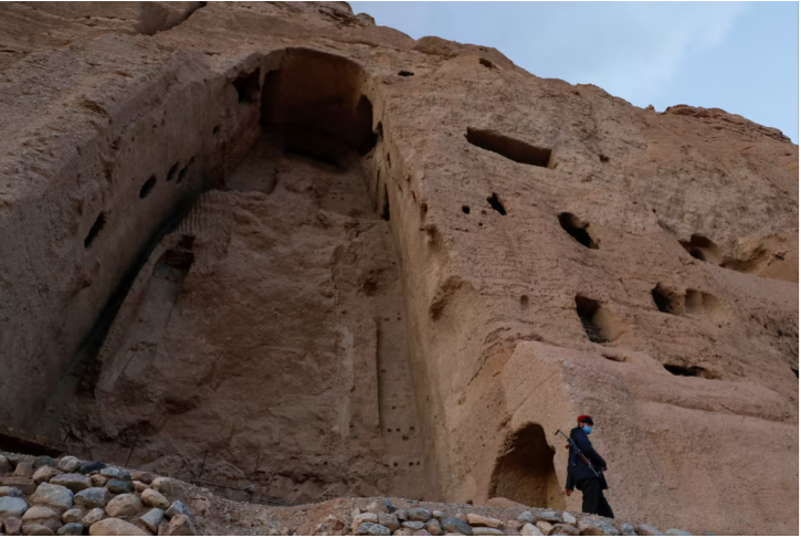 a taliban soldier stands guard in front of the ruins of a 1500 year old buddha statue in bamyan afghanistan march 2 2023 reuters ali khara file photo