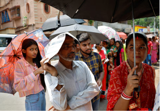 a man uses a newspaper as others use umbrellas to protect themselves from the heat as they wait to vote outside a polling station during the fifth phase of india s general election in howrah district of the eastern state of west bengal india may 20 2024 reuters sahiba chawdhary a man uses a newspaper as others use umbrellas to protect themselves from the heat as they wait to vote outside a polling station during the fifth phase of india s general election in howrah district of the eastern state of west bengal india may 20 2024 reuters sahiba chawdhary