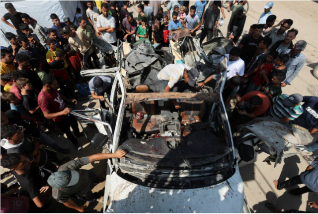 palestinians inspect a vehicle hit in an israeli strike amid israel hamas conflict in deir al balah in the central gaza strip june 4 2024 photo reuters