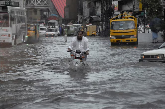 a man rides on a motorcycle amid flood waters along a road during the monsoon season in rawalpindi pakistan july 19 2023 reuters waseem khan