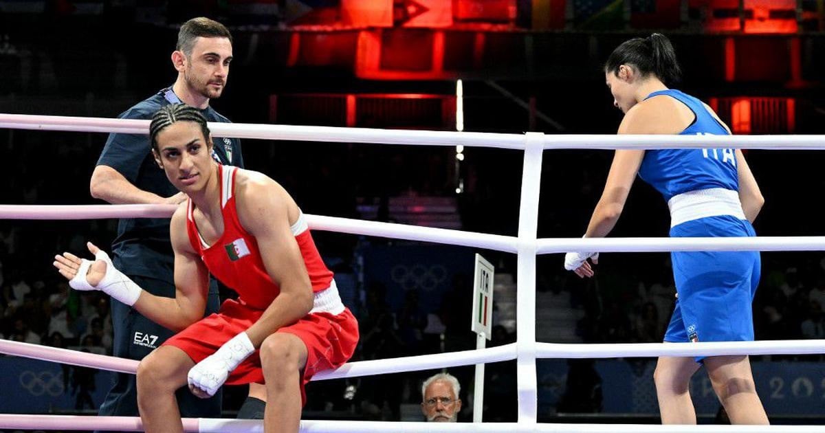 algeria s imane khelif in red and italy s angela carini leave after their women s 66kg preliminaries round of 16 boxing match during the paris 2024 olympic games at the north paris arena photo afp