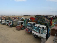 trucks loaded with afghans and their belongings wait to cross at chaman in pakistan earlier in november photo afp