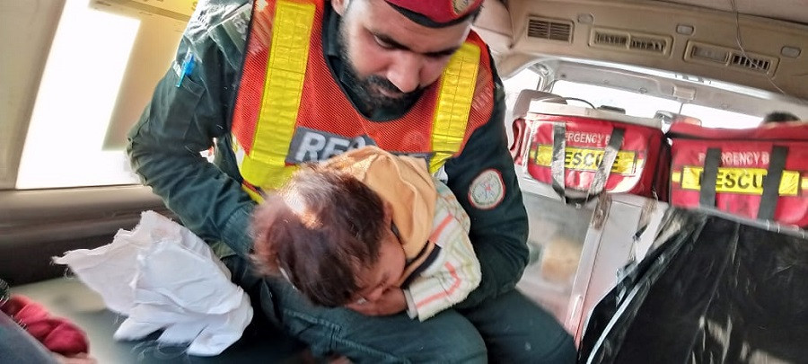 paramedic technician rescue 1122 tauqeer ahmed pictured while providing first aid to the one year old in rawalpindi on dec 1 photo express